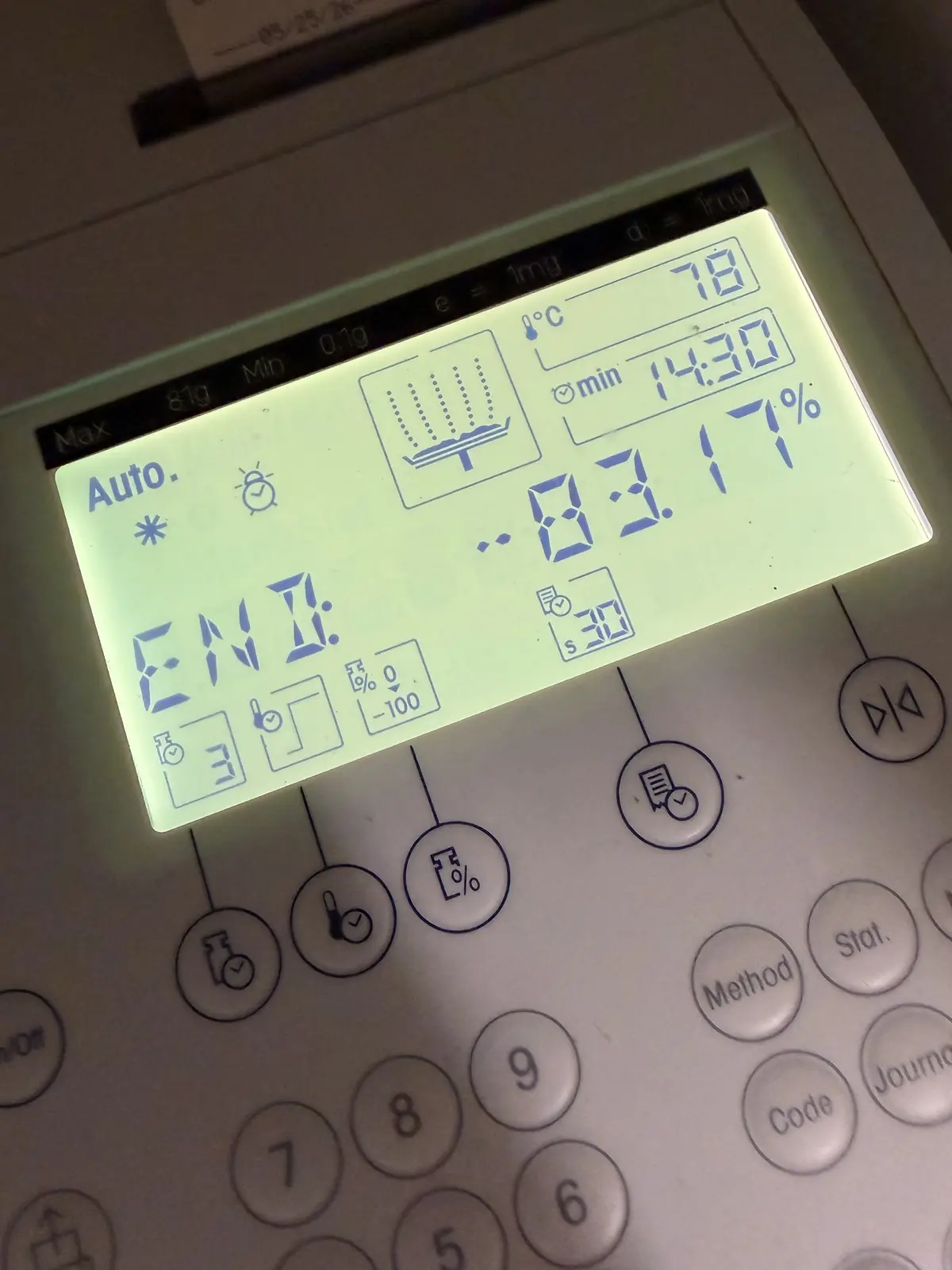 Halogen moisture analyser display showing 83.17% moisture content in fresh spruce buds